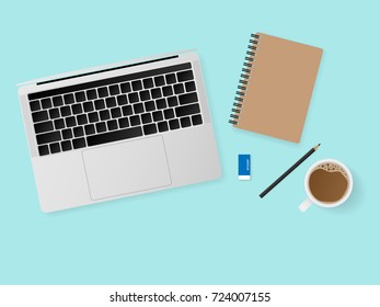Top view working desk with laptop computer, notebook, pencil and a cup of coffee isolated on blue background