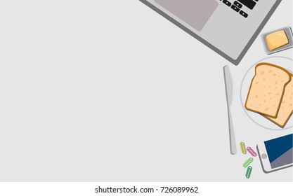 Top view of working desk with laptop, mobile phone, and breakfast with toast and butter and with copy space for your own text