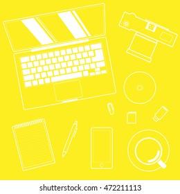 Top view of workplace and accessories on table, yellow.