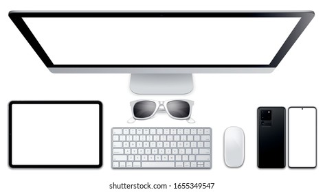 Top view of the workplace computer, keyboard, tablet, smartphone, glasses, mouse