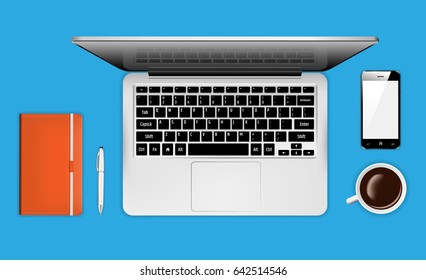 Top view of workplace with laptop, phone, pen and notebook 