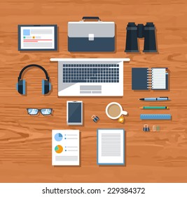 Top view of workplace with notebook, tablet, smartphone, office items and devices on pink background