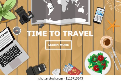 Topdown flat view of table with world map, laptop,camera,tree,compass,passport and plane's ticket while planing for traveling with copy space for text"TIME to TRAVEL"  for holiday wallpaper,poster