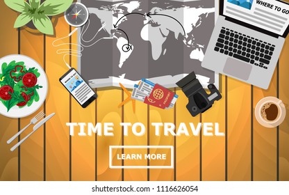 Topdown flat view of table with world map, laptop,camera,tree,compass,passport and plane's ticket while planing for traveling with copy space for text"TIME to TRAVEL"  for holiday wallpaper,poster