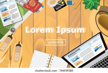 Topview of the traveler's wooden desk, plan for the trip with shoes, empty notebook, laptop computer, summer hat, tablet, passport with economy class plane ticket, and compass on the wooden table