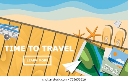 Topview of wooden balcony with map, guide book, plane ticket, compass, and shoe with text " Time to Travel" in copy space for Summer holiday outdoor travel concept