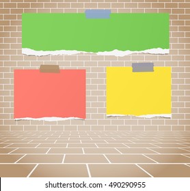 Torn colorful blank paper sheets stuck on brown brick wall