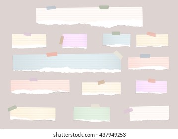 Torn colorful note paper pieces are stuck with sticky tapes on pink background