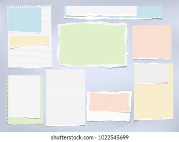 Torn colorful and white note, notebook paper strips stuck on blue background