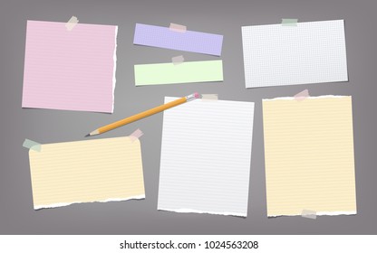 Torn colorful and white note, notebook paper strips, sheets, pencil for text stuck with adhesive tape on dark gray background.