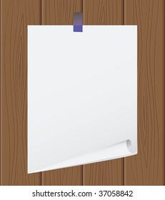 The torn off sheet of paper on wooden structure