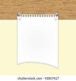 Torn paper note holding by nails on wood board.