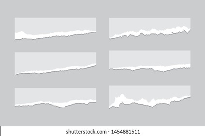 Torn sheets of paper. A set of torn paper and strips of paper on a dark background. Vector illustration.