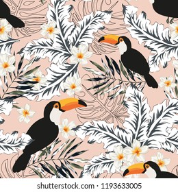 Toucans, graphic palm leaves, plumeria flowers, pale pink background. Vector floral seamless pattern. Tropical illustration. Exotic plants, birds. Summer beach design. Paradise nature