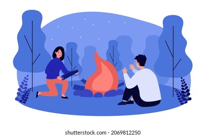 Tourist burning campfire in wild forest at night. Man and woman sitting around fire flat vector illustration. Camping scene, travel adventure concept for banner, website design or landing web page