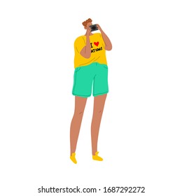 Tourist man in a yellow t-shirt taking a picture with the digital camera. Vector illustration in flat cartoon style