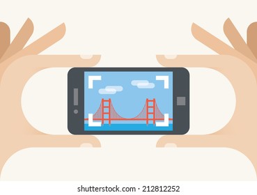 Tourist mobile phone camera taking Golden Gate bridge photo, San Francisco, California. Concepts: photography sharing services (Instagram), tourism, holiday, travel, famous places, vacation, blogging