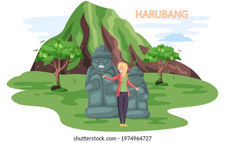 Tourist takes photo near stone sculptures and tropical plants in Stone park. Statue of dol hareubang tourist attraction on Jeju Korean island. Travel to South korea. Welcome to Jeju, vacation in Asia