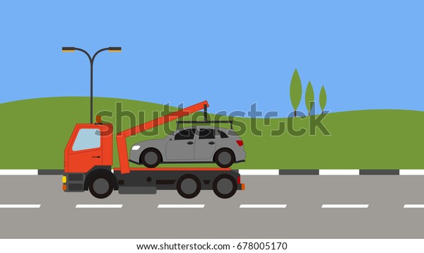 Tow truck picking up a car\
in town