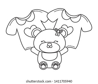 toy bear and baby clothes black and white