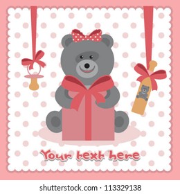 the toy bear holds a gift