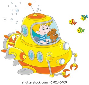 Toy deep-sea bathyscaphe piloting by a little boy with his pup