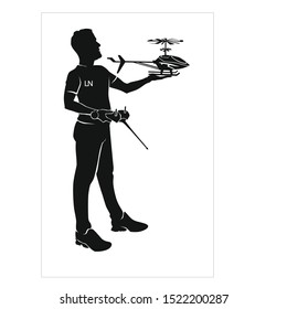toy helicopter with remote control in the hands of a man. Hobby to let toy helicopters