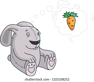 toy rabbit sitting on the ground and dreaming about carrot