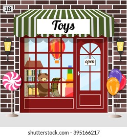 Toy Shop (toy Store) Building Facade. Brown Brick. Doll House, Bear, Balloon And Drum In The Window. EPS 10 Vector.