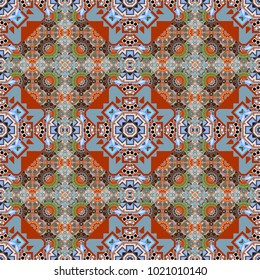Tracery seamless pattern. Ethnic colorful doodle texture in gray, blue and orange colors. Vector curved doodling background. Mehndi design.
