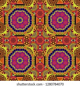 Tracery seamless pattern in Mehndi style. Vector illustration. Curved doodling background. Ethnic colorful doodle texture in orange, yellow and brown colors.
