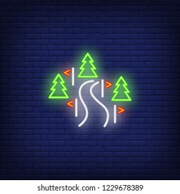 Track in forest neon sign. Glowing illustration of ski pass with red flags in green forest on dark blue brick background. Can be used for sport, winter games, ski