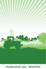 tractor in a field in front of a cityscape