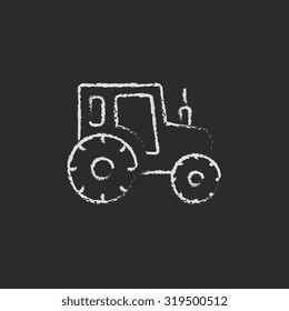 Tractor sketch icon hand drawn in chalk on a blackboard vector white icon isolated on a black background.