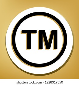 Trade mark sign. Vector. Black icon with light brown shadow in white circle with shaped ring at golden background.