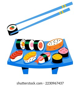 Traditional Asian Sushi food. Sashimi, rolls, on a wooden tray. Chopsticks hold sushi