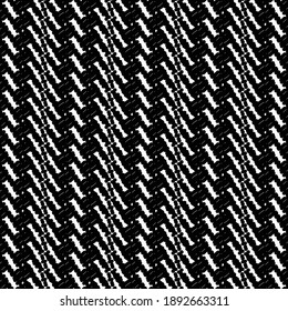 Traditional carpet in black and white, patterned with oblique stripes and small rectangles. Wool or cotton shawl with decorative strips.