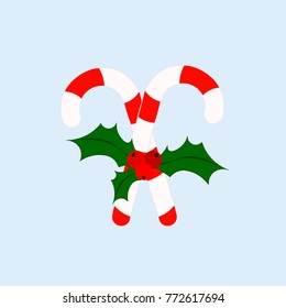 Traditional Christmas candy with bow and holly on white background
