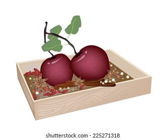 A Traditional Christmas Food of Delicious Red Christmas Apples with Cinnamon Sticks and Anise in Wooden Box for Christmas Celebration. 