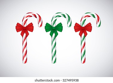 Traditional christmas green and red candy canes with red bow ribbon isolated on white background.