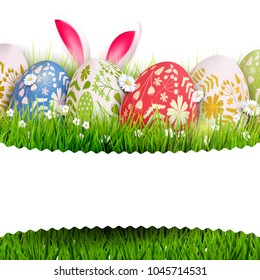 Traditional Easter background with colorful painted Easter eggs and bunny ears in the grass. 
Place for your message
