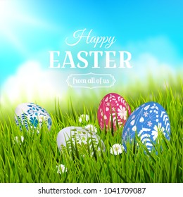 Traditional Easter greeting card with colorful painted Easter eggs in the grass. 