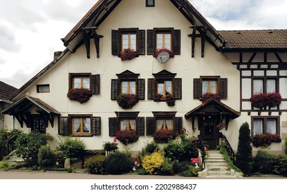 Traditional German house ornated with flowers. Summer day view.
