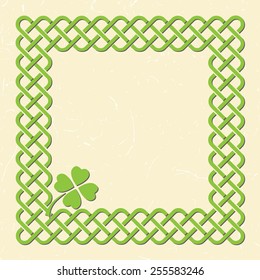 Traditional green celtic style braided knot frame with shamrock leaf over textured vintage background.