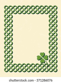 Traditional green celtic style braided knot frame with shamrock leaf over textured vintage background.
