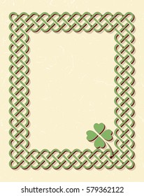 Traditional green celtic style braided knot frame with shamrock leaf over textured vintage background.