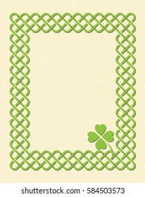 Traditional green celtic style braided knot frame with shamrock leaf over textured vintage background.
