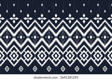Traditional Ikat textile pattern. Seamless ethnic fabric background. Tribal-inspired woven print. White on indigo texture. Ikat design. Geometric diamond shape design. Handwoven traditional pattern.