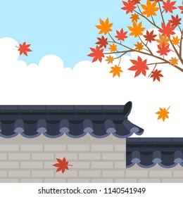 Traditional Korean style stone wall fence with maple tree on sky background