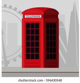 Traditional London red telephone cabin. Skyline in the background. 